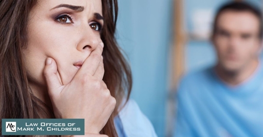 woman looking concerned as man looks at her