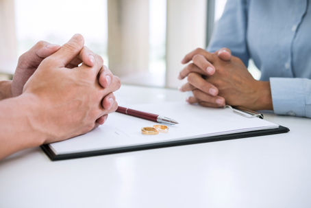 couple signing divorce papers