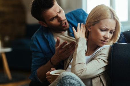 couple with relationship difficulties arguing about their problems at home
