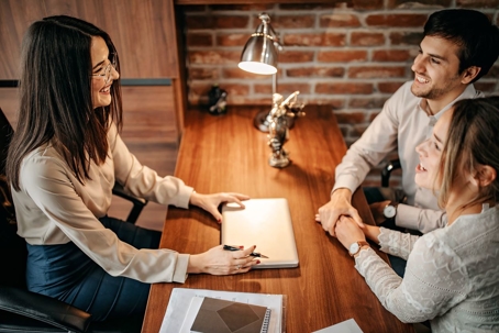 couple discussing prenuptial agreement with attorney