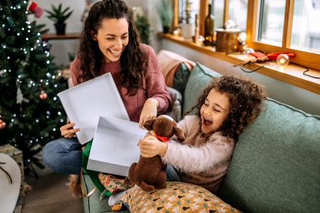 mother and daughter opening Christmas presents