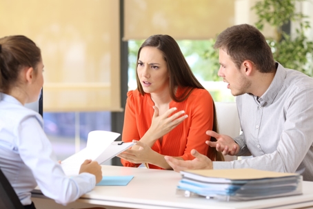 couple arguing in a lawyer's office