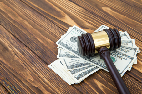 money pinned under a gavel