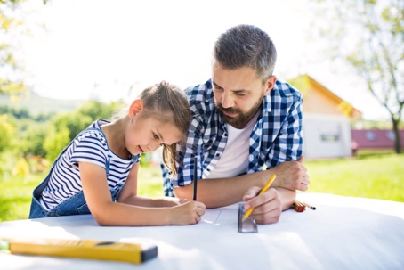 father and daughter doing a project
