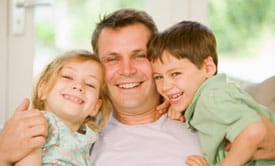 father hugging daughter and son